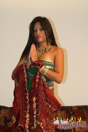 Grey eyed indian girl in green outfit undressing and exposing her black thongs and big juggs on the sofa - Picture 4