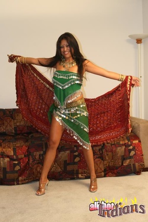 Grey eyed indian girl in green outfit undressing and exposing her black thongs and big juggs on the sofa - Picture 5
