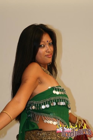 Grey eyed indian girl in green outfit undressing and exposing her black thongs and big juggs on the sofa - Picture 6