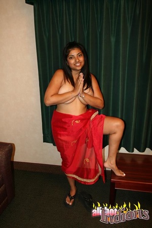 Red saree dressed indian gal with big titties stripteasing and exposing her goods on the table - Picture 5