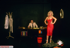 Alluring blonde seduces her handsome boss as she takes off her green bandana and coat and displays her luscious body in red dress and white high heels before she lets him lick her twat on his wooden desk. - Picture 6
