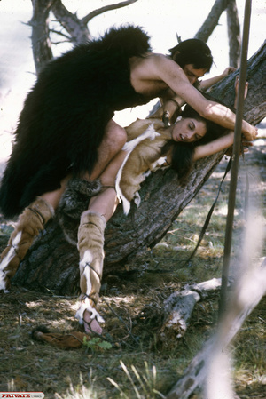 Smoking hot amazon babe in brown and white fur coat and boots displays her indulging body before she gets abducted by a hunk cave man then lets him fuck her in different styles in a forest. - Picture 6