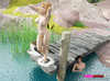 Chap is bound to a dock while a blonde Domme puts her feet and pussy in