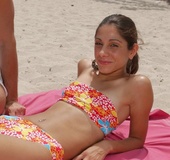 Picked up on the beach brunette gets undressed and giving a head to muscular
