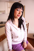 Busty black haired beauty undressing and exposing her shaved holes before