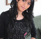 Long haired gal in black lingerie posing and undressing on the couch and