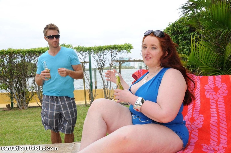 Luscious plus size redhead in blue bathing suit and pink - Picture 9