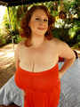Steaming hot redhead in orange dress - Picture 4