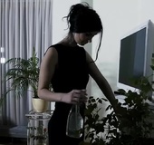 Bored housewife in black knickers plays on white couch