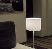 Dirty brunette gags herself on the grey couch as she cums