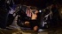 Sexy brunette chick is posing topless near a motorcycle, kissing and licking