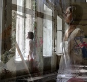 Short haired cutie in white shirt and black heels stands in graffiti filled