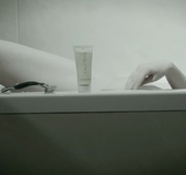 Blonde sits down in her bathtub for a nice black and white relaxation