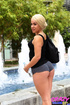 Blonde college coed in a black tank gives her guy the goods in public.