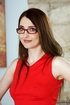Nerdy brunette tutor in red dress taught sex-ed to a young man in blue
