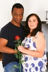 Brunette MILF in white floral dress sucks young black cock in the kitchen