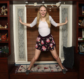 Young blonde with a slim body alone at home plays with toys from her makeup