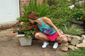 Pretty young girl in a pink skirt puts the water hose in her pussy outside - XXXonXXX - Pic 1