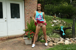 Pretty young girl in a pink skirt puts the water hose in her pussy outside - Picture 5