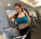 This sexy redhead works out with her big tits out for the world to see