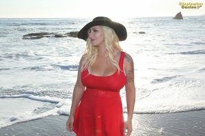 Sexy brown eyed pin-up with massive boobs poses in red dress at the beach - XXXonXXX - Pic 1