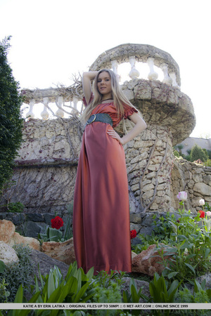 Blonde in red gown likes to stroll at the garden and gets naked on the stones - XXXonXXX - Pic 2