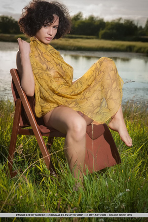 Busty brunette with yellow scarf strikes a pose in the grain fields with her pussy - Picture 1