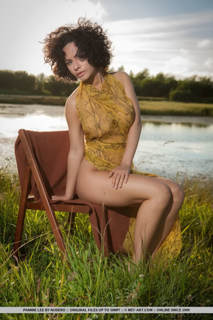 Busty brunette with yellow scarf strikes a pose in the grain fields with her pussy - Picture 2