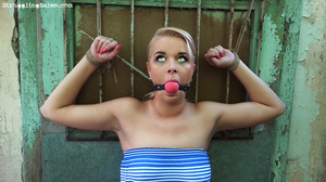 Hot blonde in blue bound standing, gagged, tits sucked, vibrated and sprayed water - Picture 1