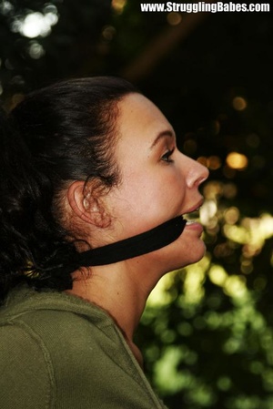 Lusty brunette in jeans pants and green top gagged and tied to bamboo tree - XXXonXXX - Pic 10
