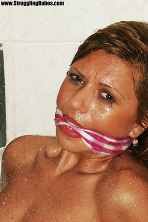 Hot tits brunette in pink towel overpowered, tied, gagged and dropped in bath tub - Picture 11
