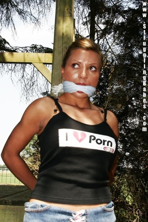 Sexy brunette in black top and jeans shorts gagged and tied hands back outdoors - XXXonXXX - Pic 10