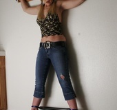 Tasty blonde in sexy top and jeans pants bound hands and legs apart