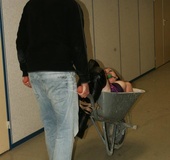 Lovely brunette in purple top bound in wheel barrow, gagged and squeezed