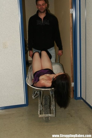 Lovely brunette in purple top bound in wheel barrow, gagged and squeezed - Picture 12