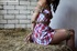Brunette beauty in checkered dress roped, gagged and hog tied in barn