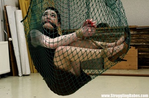 Fresh dark hair cutie in black suspended in fishnet, gagged and bound - Picture 4