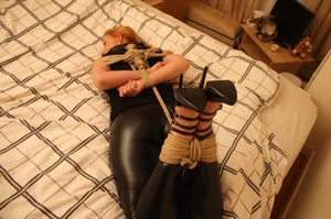 Sweet shapely blonde in black top and pants roped, bound and gagged on bed - Picture 5