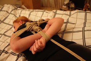 Sweet shapely blonde in black top and pants roped, bound and gagged on bed - Picture 8