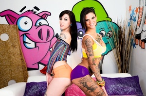 Tatted up brunette posing with an equally tatted up brunette - Picture 4