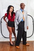 Ebony babe in a red shirt posing with her black boss