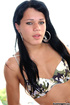 Tattooed ladyboy raven with belly jewel wears sneakers while holding her