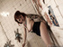 Plumpy tattooed redhead in glasses squats on nasty public bathroom wall