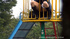 Two naughty minxes are having fun on  a playground, pissing on one another