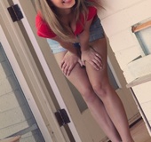 Young chick in red top and plaid skirt shows her body off through screen