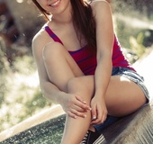 Hottie in red and blue top and denim shorts takes her cloths of outdoors