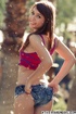 Hottie in red and blue top and denim shorts takes her cloths of outdoors