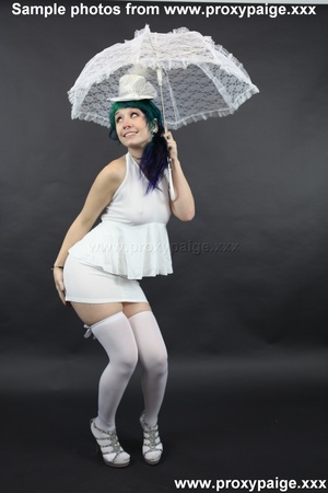 Teen cutie in white suit, hat, stockings and umbrella playing with her asshole prolapse - Picture 1