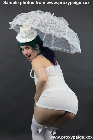 Teen cutie in white suit, hat, stockings and umbrella playing with her asshole prolapse - Picture 3
