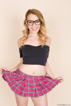Teen hottie with glasses pose her banging body before she takes off her black off shoulder shirt and bares her petite tits then peels down her pink and blue skirt and white panty and expose her lusty pussy in a brown room. - XXXonXXX - Pic 4